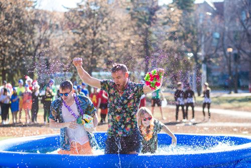 MIKAELA MACKENZIE / WINNIPEG FREE PRESS
Daniel Mortimer raises his arms victoriously after jumping into an icy pool with teammates Kevin Collins (left) and Jordan Karlson to raise money for the United Way at the University of Manitoba in Winnipeg on Thursday, Oct. 18, 2018. 
Winnipeg Free Press 2018.