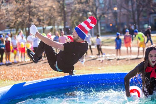 MIKAELA MACKENZIE / WINNIPEG FREE PRESS
Riley Sova jumps into an icy pool with his teammate, Julya Zan, to raise money for the United Way at the University of Manitoba in Winnipeg on Thursday, Oct. 18, 2018. 
Winnipeg Free Press 2018.