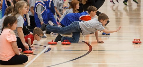 MIKE DEAL / WINNIPEG FREE PRESS
Grade three student, Dean Papanikolaou, from West St. Paul School, throws a rock during a floor curling tournament at the Sport for Life Centre Thursday morning. CurlManitoba hosted one of Canadas largest youth floor curling tournaments, over 550 students from twelve schools and five School Divisions took part.
181018 - Thursday, October 18, 2018.