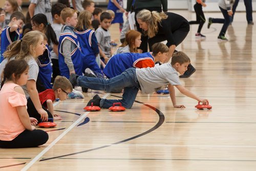 MIKE DEAL / WINNIPEG FREE PRESS
Grade three student, Dean Papanikolaou, from West St. Paul School, throws a rock during a floor curling tournament at the Sport for Life Centre Thursday morning. CurlManitoba hosted one of Canadas largest youth floor curling tournaments, over 550 students from twelve schools and five School Divisions took part.
181018 - Thursday, October 18, 2018.