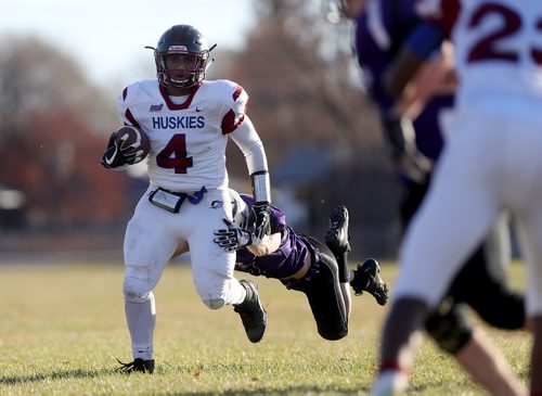 TREVOR HAGAN / WINNIPEG FREE PRESS
Sturgeon Heights Huskies quarterback, Kiran Jayabalan (4), carrying the ball in front of Vincent Massey Brandon Kristjen Frederickson (57), Thursday, October 18, 2018. Sports agate