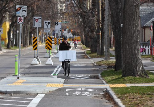 MIKE DEAL / WINNIPEG FREE PRESS
Cyclists use the new bike lane on McDermot Avenue Friday afternoon. 
181019 - Friday, October 19, 2018