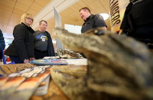 TREVOR HAGAN / WINNIPEG FREE PRESS
Diane and Early Benoit speaking with Border Services Officer, Fred Presber at their display of confiscated items during an open house at the Winnipeg Airport, Saturday, October 20, 2018.