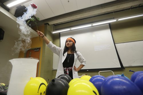 TREVOR HAGAN / WINNIPEG FREE PRESS
Kristine Macalinao, assistant coordinator for Let's Talk Science, and a 4th year genetics student holding a rose she froze with liquid nitrogen during a magic show during the Spooky Science event at the University of Manitoba, Saturday, October 20, 2018.