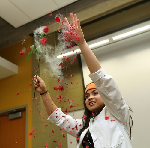 TREVOR HAGAN / WINNIPEG FREE PRESS
Kristine Macalinao, assistant coordinator for Let's Talk Science, and a 4th year genetics student crumbling a rose she froze with liquid nitrogen during a magic show during the Spooky Science event at the University of Manitoba, Saturday, October 20, 2018.