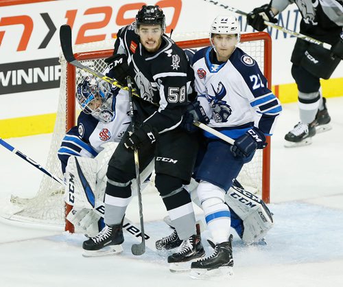JOHN WOODS / WINNIPEG FREE PRESS
Manitoba Moose goaltender Eric Comrie (1) tries to see around a San Antonio Rampage player as Manitoba's Kristian Reichel (22) defends during first period AHL action in Winnipeg on Monday, October 21, 2018.