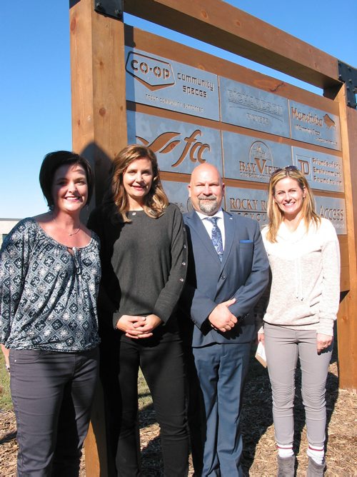 Canstar Community News Oct. 17, 2018 - (From left) Sanford Community Greenspace project co-chairs Carolyn Krawitz, Sarah Bestlabd and Christine Kabernick with J.A. Cuddy School principal Scott Thomson stand in front of the donor board listing the agencies and businesses that provided grants for the greenspace project. The other side of the baord includes individuals and business donors that contributed to the $240,000 project. (ANDREA GEARY/CANSTAR COMMUNITY NEWS)