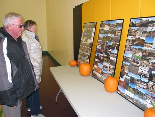 Canstar Community News Oct. 17, 2018 - Guests at the Sanford Community Greenspace's official opening look at a photo display showing the greenspace project's progress over three years. (ANDREA GEARY/CANSTAR COMMUNITY NEWS)
