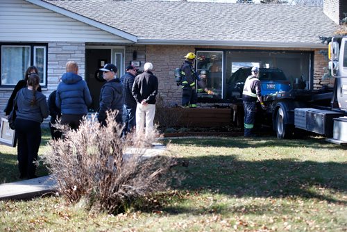 JOHN WOODS / WINNIPEG FREE PRESS
Emergency personnel were called to remove a car from the living room at 236 Handsart Blvd Tuesday, October 23, 2018.
An SUV drove through the front of a home on the 200 block of Handsart Boulevard Tuesday afternoon. Police were dispatched to the scene at 2:15 p.m. While there was extensive damage to the home, no one was injured in the incident.