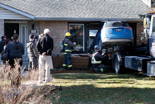 JOHN WOODS / WINNIPEG FREE PRESS

Emergency personnel were called to remove a car from the living room at 236 Handsart Blvd Tuesday, October 23, 2018.
An SUV drove through the front of a home on the 200 block of Handsart Boulevard Tuesday afternoon. Police were dispatched to the scene at 2:15 p.m. While there was extensive damage to the home, no one was injured in the incident.