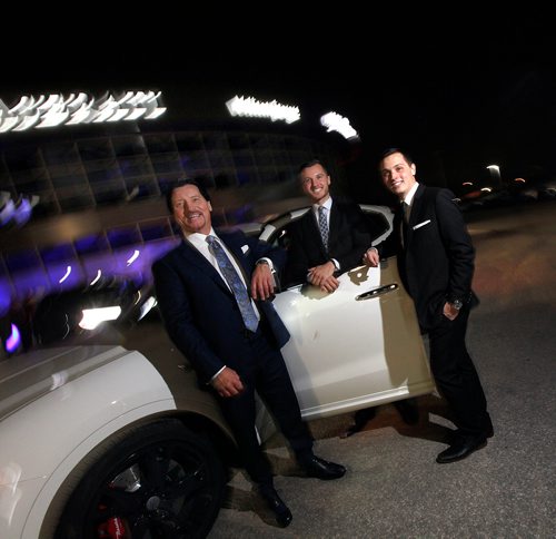 PHIL HOSSACK / WINNIPEG FREE PRESS - Maseratti dealership owners Walt Morris and his sons Jared (centre) and Brendan (right) pose with a but of product at a grand opening for the dealership in Winnipeg THursday. See story. - October 25, 2018