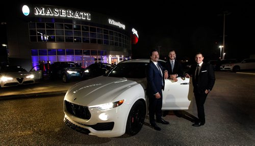 PHIL HOSSACK / WINNIPEG FREE PRESS - Maseratti dealership owners Walt Morris and his sons Jared (centre) and Brendan (right) pose with a but of product at a grand opening for the dealership in Winnipeg THursday. See story. - October 25, 2018