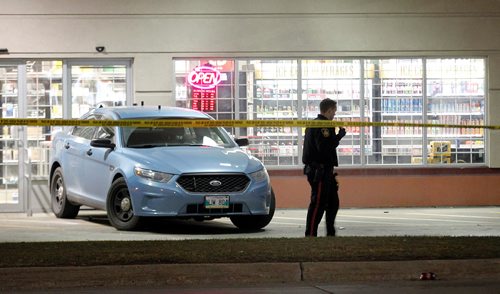 PHIL HOSSACK / WINNIPEG FREE PRESS - A city police officer checks the scene at the Bottle Stop on Plaza Drive where a knife weilding man was taken into custody THursday evening. See story. - October 25, 2018