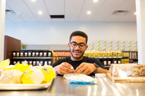 MIKAELA MACKENZIE / WINNIPEG FREE PRESS
Youssef Ahmed puts price stickers up before Blady Middle Eastern market opens in Winnipeg on Friday, Oct. 26, 2018. 
Winnipeg Free Press 2018.