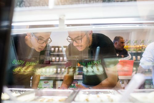 MIKAELA MACKENZIE / WINNIPEG FREE PRESS
Saif Raafat (left) and Youssef Ahmed put price stickers up before Blady Middle Eastern market opens in Winnipeg on Friday, Oct. 26, 2018. 
Winnipeg Free Press 2018.