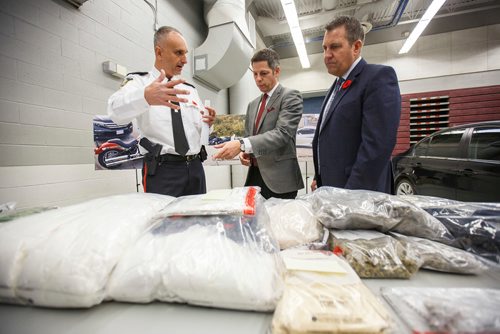 MIKE DEAL / WINNIPEG FREE PRESS
Winnipeg police Inspector Max Waddell talks to Winnipeg Mayor Brian Bowman and Cliff Cullen Minister of Justice and Attorney General at the MPI depot on Plessis Rd Thursday morning during an announcement that a major Inter-Provincial Illicit Drug Network was dismantled during Project Riverbank.   
181101 - Thursday, November 01, 2018.