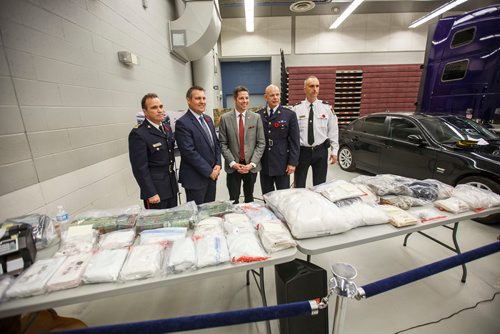 MIKE DEAL / WINNIPEG FREE PRESS
Winnipeg Chief of Police Danny Smyth, Cliff Cullen Minister of Justice and Attorney General, Winnipeg Mayor Brian Bowman, Scott Kolody, Commanding Officer of the Manitoba RCMP, and Winnipeg police Inspector Max Waddell at the MPI depot on Plessis Rd Thursday morning during an announcement that a major Inter-Provincial Illicit Drug Network was dismantled during Project Riverbank.   
181101 - Thursday, November 01, 2018.