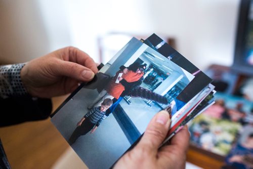 MIKAELA MACKENZIE / WINNIPEG FREE PRESS
Anita Cenerini, who fought for her son to receive full military honours after his suicide and is the 2018 National Silver Cross Mother, looks through photos of her son in her home in Winnipeg on Thursday, Nov. 1, 2018. 
Winnipeg Free Press 2018.