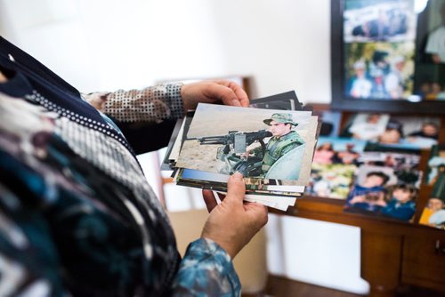 MIKAELA MACKENZIE / WINNIPEG FREE PRESS
Anita Cenerini, who fought for her son to receive full military honours after his suicide and is the 2018 National Silver Cross Mother, looks through photos of her son in her home in Winnipeg on Thursday, Nov. 1, 2018. 
Winnipeg Free Press 2018.