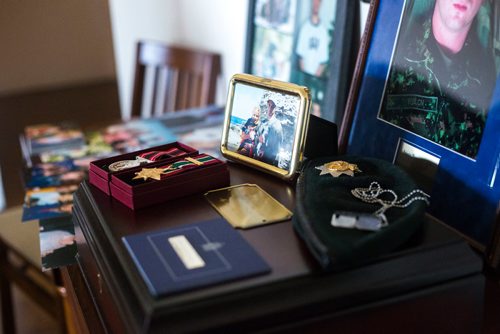 MIKAELA MACKENZIE / WINNIPEG FREE PRESS
Anita Cenerini, who fought for her son to receive full military honours after his suicide and is the 2018 National Silver Cross Mother, looks through photos of her son in her home in Winnipeg on Thursday, Nov. 1, 2018. 
Winnipeg Free Press 2018.