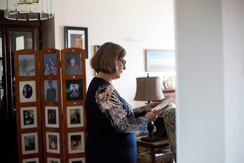 MIKAELA MACKENZIE / WINNIPEG FREE PRESS
Anita Cenerini, who fought for her son to receive full military honours after his suicide and is the 2018 National Silver Cross Mother, looks through photos of her son in her home in Winnipeg on Thursday, Nov. 1, 2018. 
Winnipeg Free Press 2018.