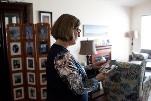 MIKAELA MACKENZIE / WINNIPEG FREE PRESS
Anita Cenerini, who fought for her son to receive full military honours after his suicide and is the 2018 National Silver Cross Mother, looks through photos of her son in her home in Winnipeg on Thursday, Nov. 1, 2018. 
Winnipeg Free Press 2018.