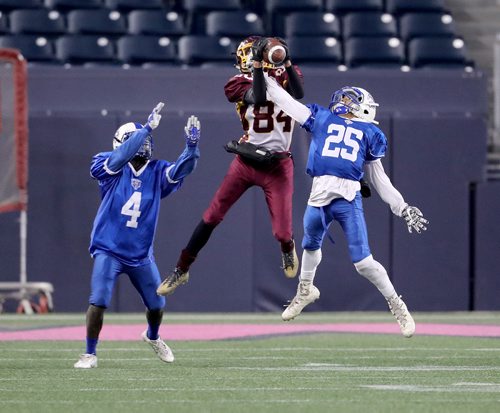 TREVOR HAGAN / WINNIPEG FREE PRESS
River East Kodiaks' Victor Mubambe (4) and Joseph Funk-Clements (25) try to break up a pass to Portage Collegiate Trojans' Colby Irwin (84) during their division 2 semi final game at Investors Group Field, Thursday, November 1, 2018.