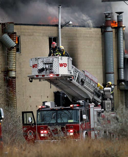 PHIL HOSSACK / WINNIPEG FREE PRESS - Firefighters position an aerial ladder truck into position fighting a fire at an oil seed crushing plant on (Google Earth lists the building as Friendly Family Farms) Dawson Road Monday afternoon. - November 05, 2018