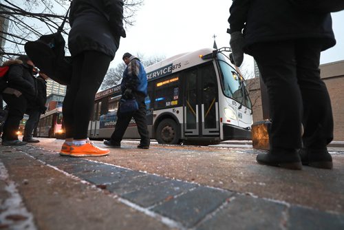 RUTH BONNEVILLE / WINNIPEG FREE PRESS

People wait to catch their bus on Graham Ave. in from of WPS Wednesday.  Moody, nondescript photo for story on bus safety.  

Nov 7th , 2018