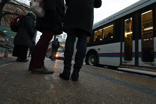 RUTH BONNEVILLE / WINNIPEG FREE PRESS

People wait to catch their bus on Graham Ave. in from of WPS Wednesday.  Moody, nondescript photo for story on bus safety.  

Nov 7th , 2018