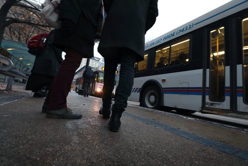 RUTH BONNEVILLE / WINNIPEG FREE PRESS

People wait to catch their bus on Graham Ave. in from of WPS Wednesday.  Moody, nondescript photo for story on bus safety.  

Nov 7th , 2018