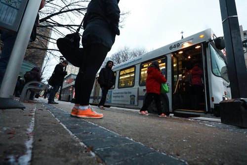 RUTH BONNEVILLE / WINNIPEG FREE PRESS

People wait to catch their bus on Graham Ave. in from of WPS Wednesday.  Moody, nondescript photo for story on bus safety.  

Nov 7th , 2018