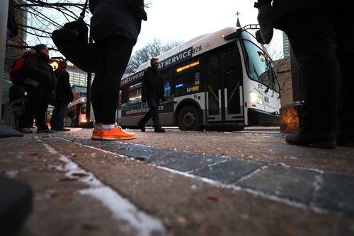 RUTH BONNEVILLE / WINNIPEG FREE PRESS

People wait to catch their bus on Graham Ave. in from of WPS Wednesday.  Moody, nondescript photo for story on bus safety.  

Nov 7th , 2018