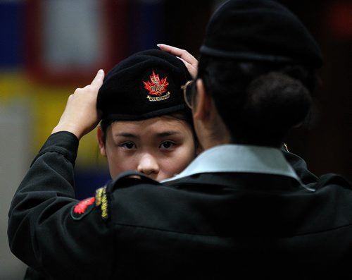 PHIL HOSSACK / WINNIPEG FREE PRESS - BORDERS - A new member gets instruction on how to wear her beret as Cadets of the 1226 Fort Garry Horse Army Cadet Corps worked their parade drill Wednesday evening preparing for ceremonies and parade on Rememberance Day at McGregor Armoury. - November 7, 2018