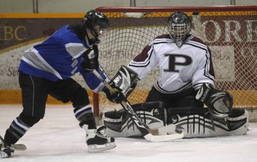 JOE BRYKSA/WINNIPEG FREE PRESS Image 4- Winkler, Manitoba-  St Paul's Crusaders goaltender Brent Wolfe, right,  keeps his eyes on the puck as  Oak Park Raiders Kevin Stambrook moves in during first period action at the 2009 AAAA High School Hockey Championships in Winkler, Manitoba Sunday- Mar 15, 2009