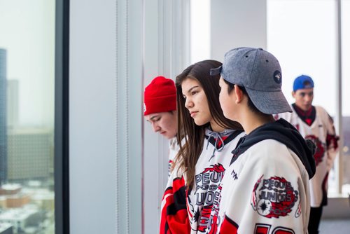 MIKAELA MACKENZIE / WINNIPEG FREE PRESS
Shanice Stevenson (centre) and other members of the Peguis Juniors (up-and-coming players not yet in the league affected) wait for a press conference to begin after a lawsuit was launched against the newly formed Capital Region Junior Hockey League at True North Square in Winnipeg on Friday, Nov. 9, 2018. 
Winnipeg Free Press 2018.