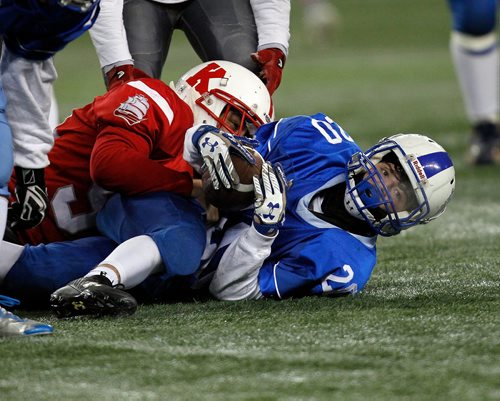 PHIL HOSSACK / WINNIPEG FREE PRESS - River East Kodiak #20 looks up from a tackle by Kelvin Clipper #94 Rylan Galbraith Friday evening at Investor's Group Field. Mike Sawatzky's story.  - November 9, 2018