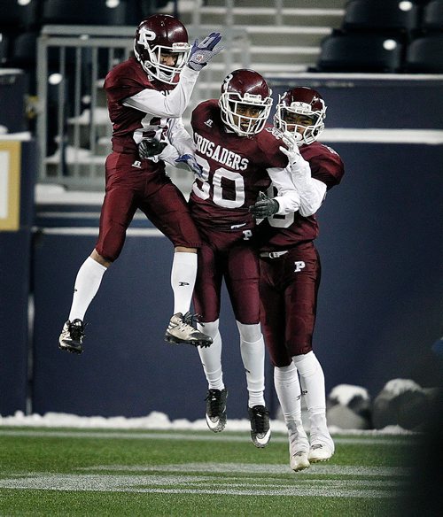 PHIL HOSSACK / WINNIPEG FREE PRESS - left to right #81 Zach Wynne, #80 Muludesta Yitna and #85 Thane Tomlinson celebrate St Pauls Crusaders touchdown early in the first quarter as the team took the lead agaisnt Vincent Massey in High School Football playoff action at Investor's Group Field Friday night.- November 9, 2018