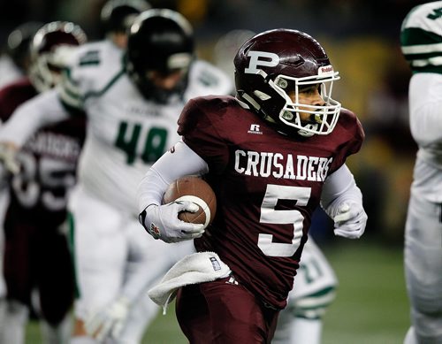 PHIL HOSSACK / WINNIPEG FREE PRESS - St Pauls Crusader #5 Jessie Te runs through traffic against the Vincent Massey Crusaders in High School Football playoff action at Investor's Group Field Friday night.- November 9, 2018