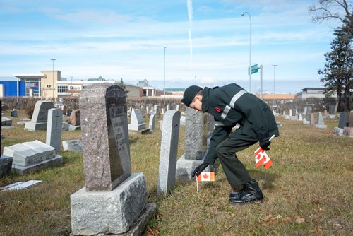 Canstar Community News Tristen Vincent places a flag on a soldier's grave. Members of Winnipeg's Princess Patricia's Canadian Light Infantry Cadet Corps visited the St. James Cemetary on Nov. 3 to place Canadian flags on the graves of more than 60 First World War soldiers. (EVA WASNEY/CANSTAR COMMUNITY NEWS/METRO)