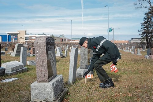 Canstar Community News Tristen Vincent places a flag on a soldier's grave. Members of Winnipeg's Princess Patricia's Canadian Light Infantry Cadet Corps visited the St. James Cemetary on Nov. 3 to place Canadian flags on the graves of more than 60 First World War soldiers. (EVA WASNEY/CANSTAR COMMUNITY NEWS/METRO)