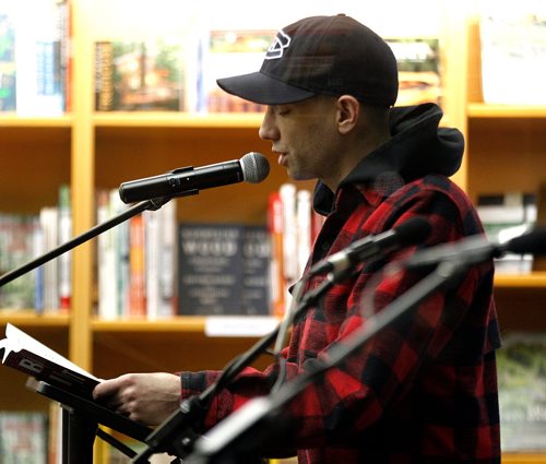 PHIL HOSSACK / WINNIPEG FREE PRESS - Seen through an outside store window, Jay Baruchel reads from his new book "Born Into It" Tuesday evening at McNally Robinson Booksellers at Grant Park. Stand-up. - November 13, 2018