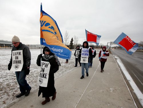 PHIL HOSSACK / WINNIPEG FREE PRESS - CUPE picketers walk the line Thursday in front of the Main postal depot on Wellington Ave near the airport. See story. - November 15, 2018