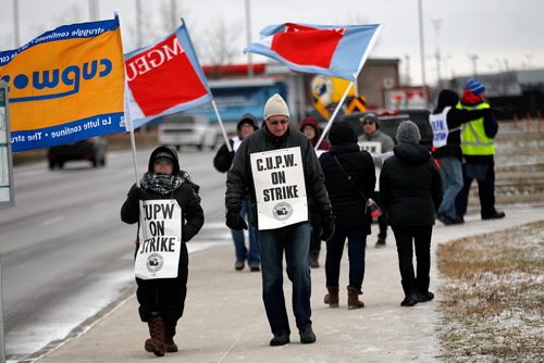 PHIL HOSSACK / WINNIPEG FREE PRESS - CUPE picketers walk the line Thursday in front of the Main postal depot on Wellington Ave near the airport. See story. - November 15, 2018