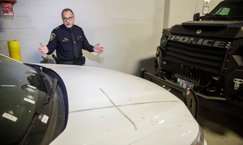 MIKE DEAL / WINNIPEG FREE PRESS
Constable Rob Carver discusses the role of the WPS armoured vehicle and the toll the incident took on officers at the scene in the recent shooting standoff on Bannerman while standing in front of a bullet damaged police cruiser and the ARV1 inside police headquarters. 
181116 - Friday, November 16, 2018.