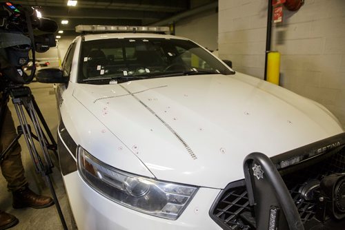 MIKE DEAL / WINNIPEG FREE PRESS
A bullet damaged police cruiser and ARV1 were the backdrop to a police media briefing inside police headquarters Friday afternoon. 
181116 - Friday, November 16, 2018.