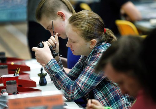 PHIL HOSSACK / WINNIPEG FREE PRESS - 11 yr old Katherine Dickson focuses as she paints a detail on a game piece Saturday afternoon. The project was part of a workshop for gamers attending the Inaugural Game-iToba convention (board games) goes Friday till Sunday at the Bronx Park Community Centre, 720 Henderson Hwy. - November 17, 2018