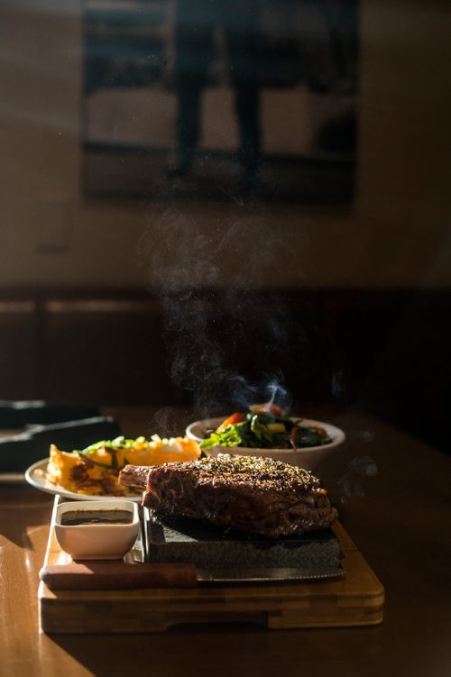 MIKAELA MACKENZIE / WINNIPEG FREE PRESS
A bone-in ribeye steak on a lava rock with a house salad and deep-fried mashed potatoes at Lot 88 in Winnipeg on Friday, Nov. 16, 2018.
Winnipeg Free Press 2018.