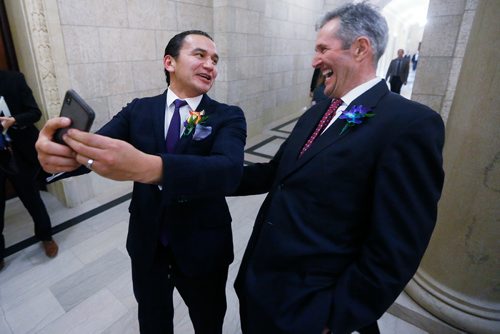 Manitoba premier Brian Pallister, right, and Manitoba opposition leader Wab Kinew pose for a selfie after the reading of the throne speech at  the Manitoba Legislature in Winnipeg, Tuesday, November 20, 2018.   THE CANADIAN PRESS/John Woods