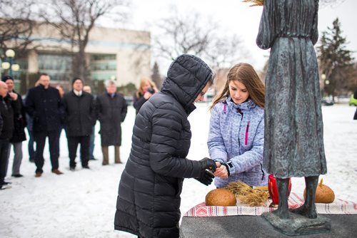 MIKAELA MACKENZIE / WINNIPEG FREE PRESS
Joanne Lewandosky (left) and Yevgeniya Tatarenko light candles as people gather to commemorate the 85th anniversary of the end of the Holodomor, a famine genocide that claimed millions of lives in Ukraine between 1932 and 1933, at the Manitoba Legislative Building in Winnipeg on Thursday, Nov. 22, 2018.
Winnipeg Free Press 2018.